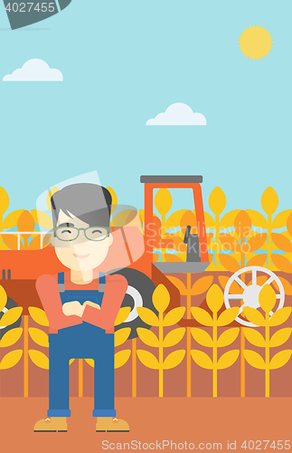 Image of Man standing with combine on background.