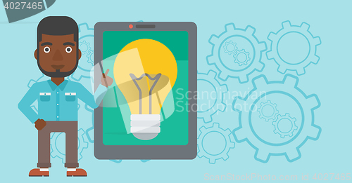 Image of Man pointing at big tablet computer.