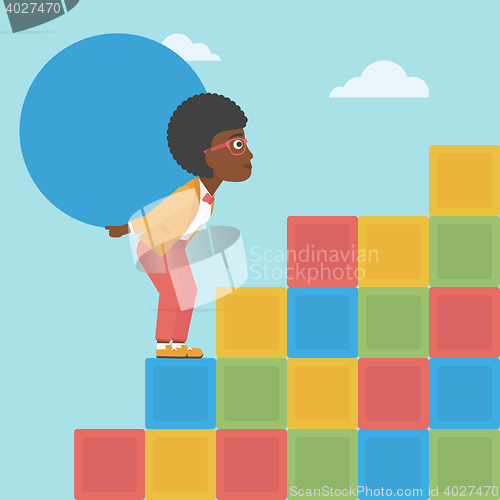 Image of Woman carrying concrete ball uphill.