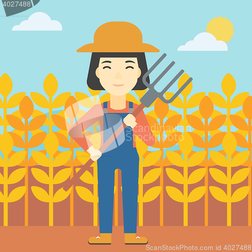 Image of Female farmer with pitchfork vector illustration.