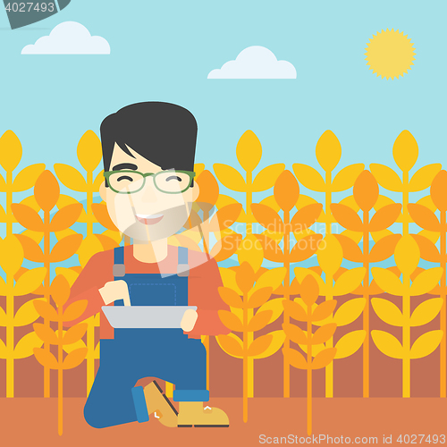 Image of Man with tablet computer on field.
