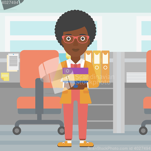 Image of Business woman holding pile of folders.