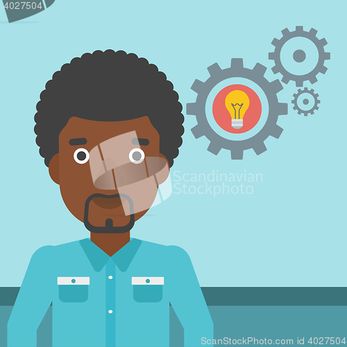 Image of Man with business idea bulb in gear.