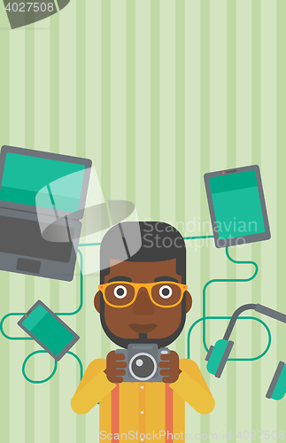 Image of Young man surrounded with his gadgets.