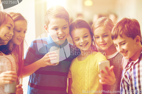 Image of group of school kids with smartphone and soda cans