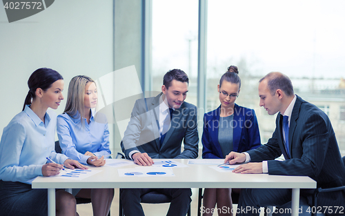 Image of business team with documents having discussion
