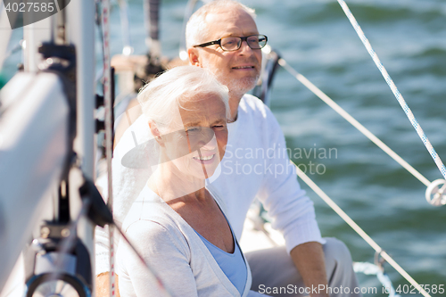 Image of senior couple hugging on sail boat or yacht in sea