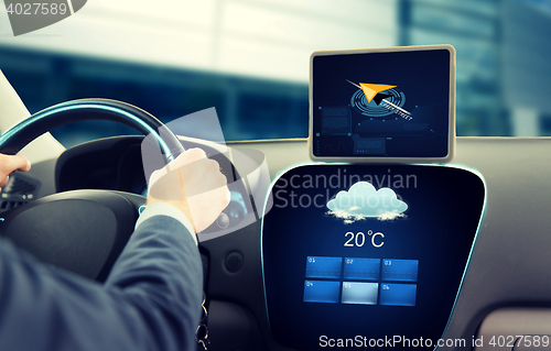 Image of close up of businessman with tablet pc driving car