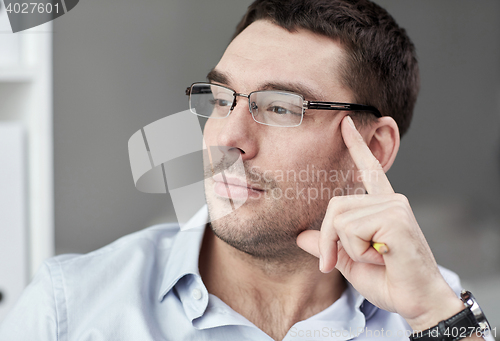Image of portrait of businessman in eyeglasses at office