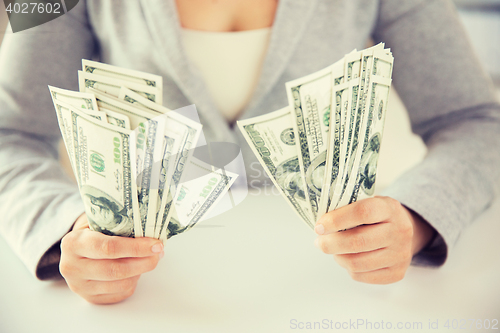 Image of close up of woman hands holding us dollar money