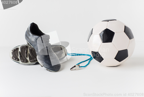 Image of close up of soccer ball, whistle and boots