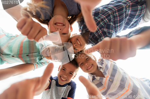 Image of happy children showing thumbs up in circle