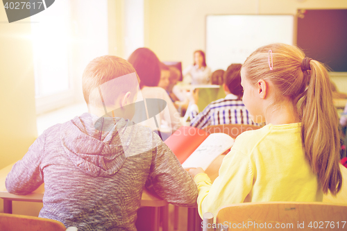 Image of group of school kids writing test in classroom