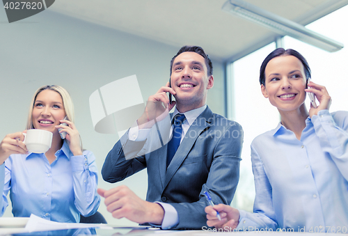 Image of business team with smartphones having conversation