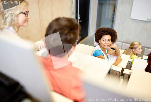 Image of group of international students talking on lecture