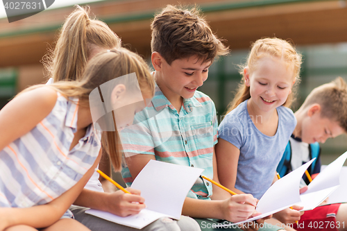 Image of group of happy elementary school students outdoors