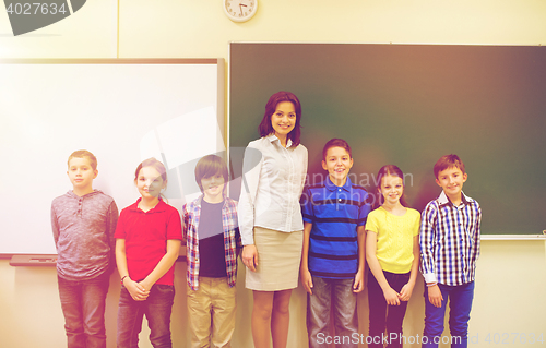 Image of group of school kids and teacher in classroom