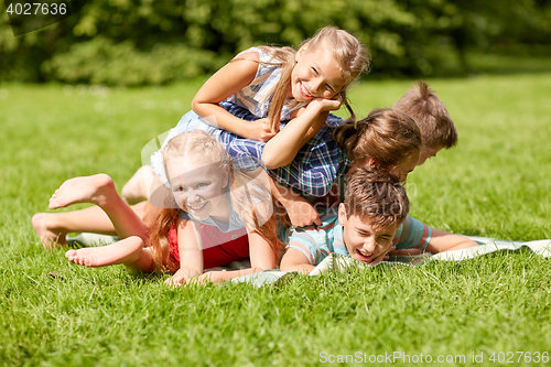 Image of happy kids playing and having fun in summer park