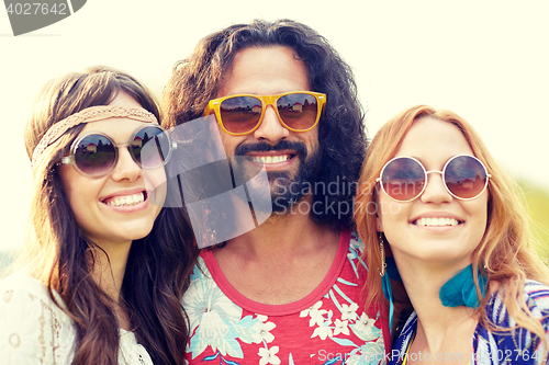 Image of smiling young hippie friends outdoors