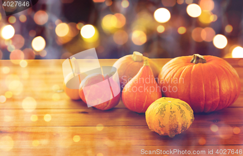 Image of close up of halloween pumpkins on wooden table