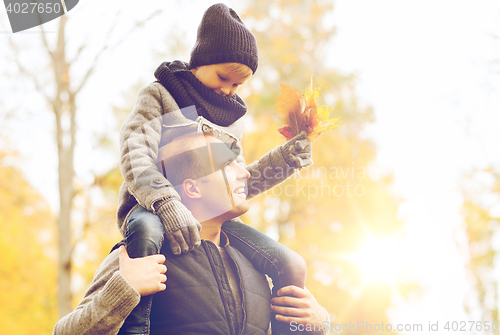 Image of happy family having fun in autumn park