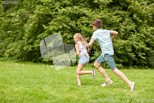 Image of happy kids running and playing game outdoors