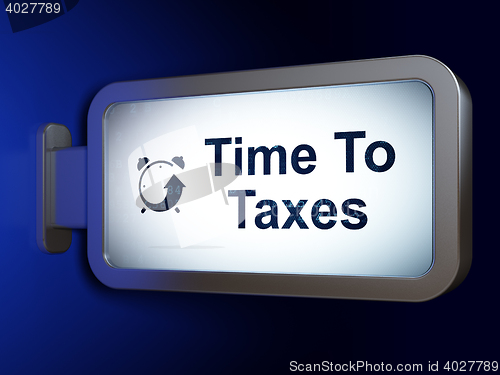 Image of Time concept: Time To Taxes and Alarm Clock on billboard background