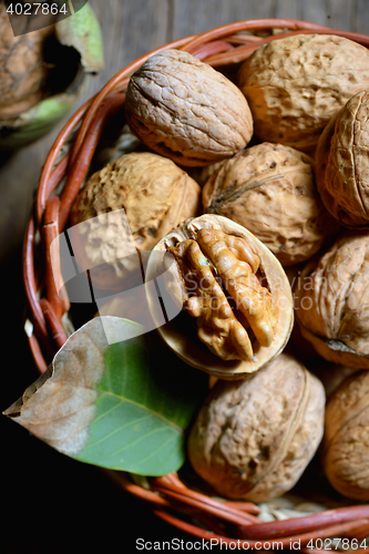 Image of Walnut in basket on rustic old wood