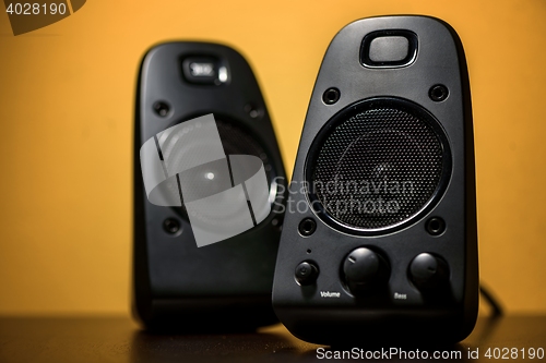 Image of Audio speakers on yellow background