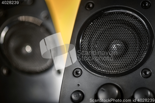 Image of Audio speakers on yellow background