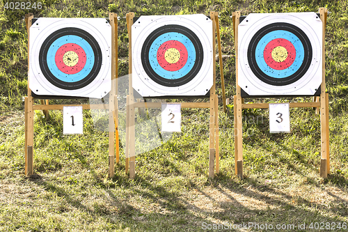 Image of Three of paper archery targets in wooden stands 