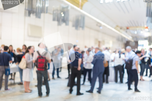 Image of Abstract blurred people socializing during coffee break at business conference.