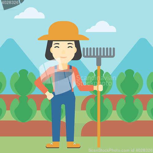 Image of Female farmer with rake vector illustration.