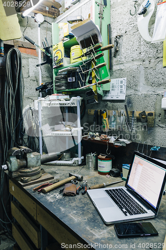 Image of View of old tools,laptop and phone on table