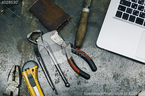 Image of Top view of old tools,laptop and phone on table