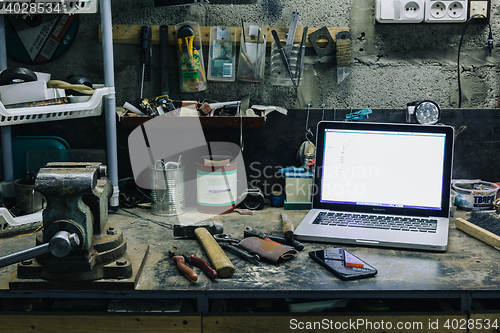 Image of View of old tools,laptop and phone on table