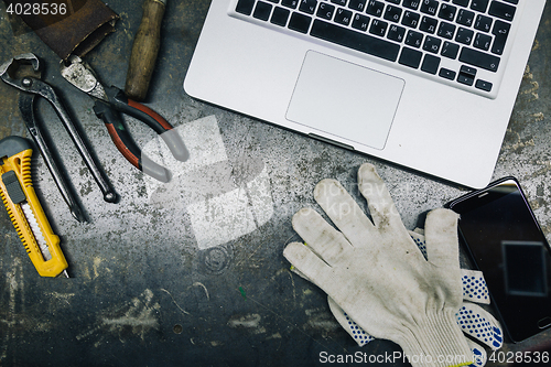 Image of Top view of old tools,laptop and phone on table