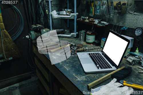 Image of View of old tools,laptop and phone on table