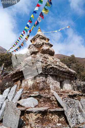 Image of Buddhism stupa or chorten with prayer flags in Himalayas
