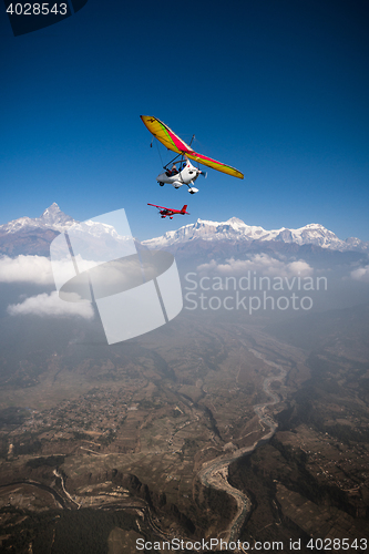 Image of Ultralight trike and plane fly over Pokhara and Annapurna region