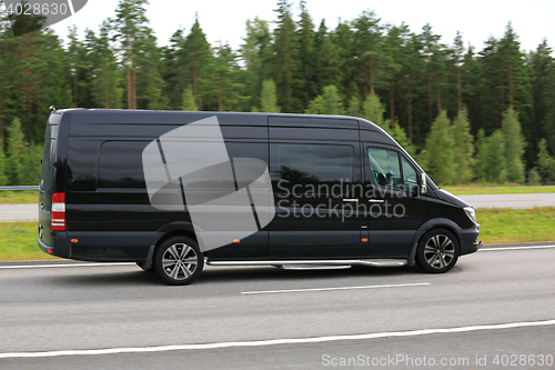 Image of Black Mercedes-Benz Van at Speed