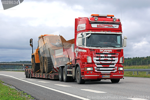 Image of Red Scania R620 V8 Hauls Mining Equipment on Freeway