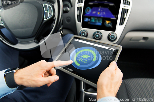 Image of close up of man with tablet pc in car