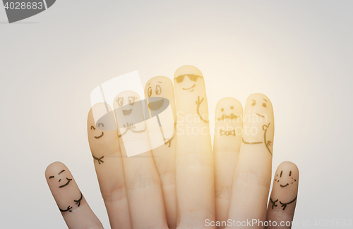 Image of close up of hands and fingers with smiley faces