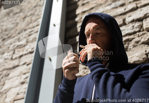 Image of close up of addict smoking marijuana joint