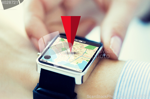 Image of close up of hands with map on smartwatch screen