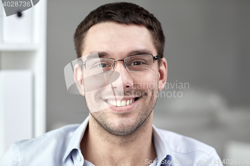 Image of portrait of businessman in eyeglasses at office