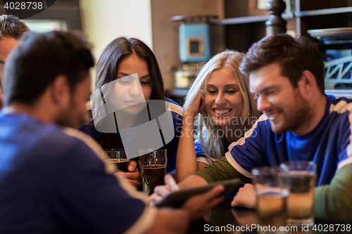 Image of football fans or friends with beer at sport bar