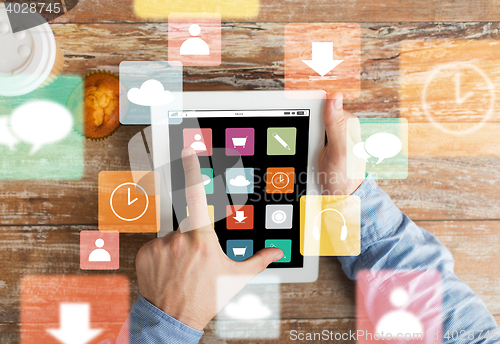Image of close up of hands with menu icons on tablet pc