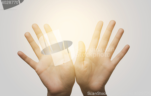 Image of close up of two hands showing palms